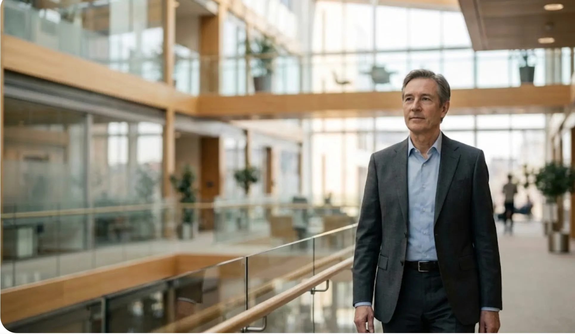 Senior executive in a modern glass-walled corporate headquarters